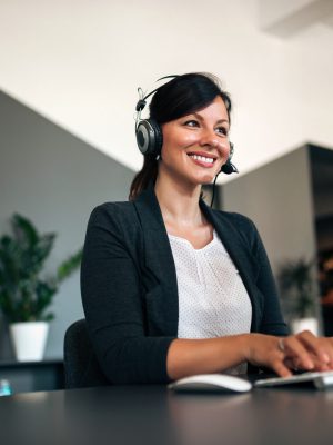 Close-up image of happy woman with headset.